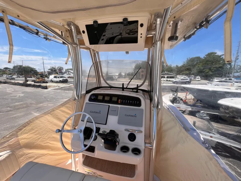 Slide: The Image of 2013 Grady-White Fisherman 257 boat cockpit with Garmin navigation system and steering wheel. - 28