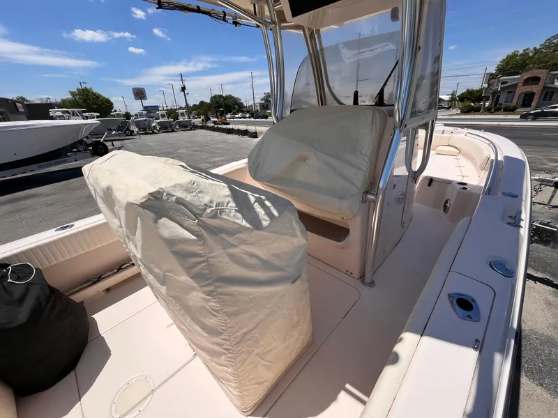 Slide: The Image of 2013 Grady-White Fisherman 257 boat interior with covered seats, parked outdoors. - 31