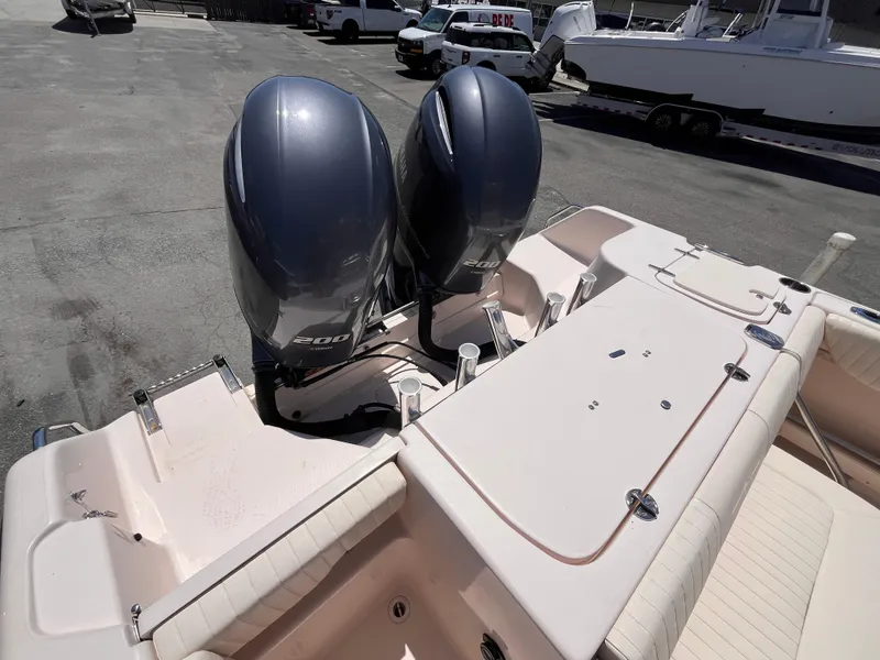Slide: The Image of 2013 Grady-White Fisherman 257 boat with dual outboard engines, docked on a sunny day. - 7