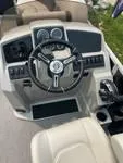 Slide: The Image of 2024 Sylvan Mirage 8522 LZ boat dashboard with steering wheel and controls. - 3