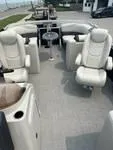 Slide: The Image of 2024 Sylvan Mirage 8522 LZ boat interior with plush seating and table. - 4