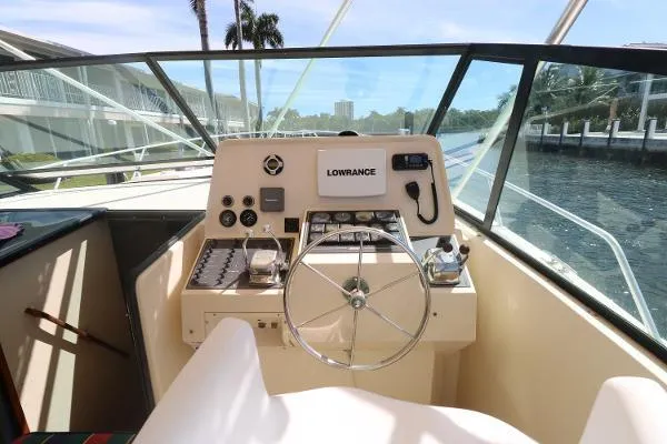 Slide: The Image of 1991 Atlantic 38 Super Sport boat helm with steering wheel and navigation equipment. - 10