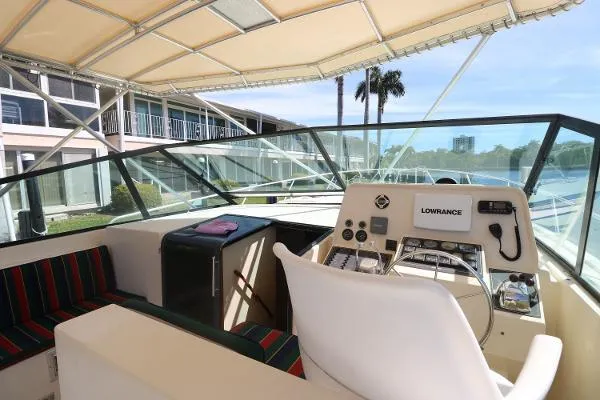 Slide: The Image of 1991 Atlantic 38 Super Sport yacht cockpit with striped seating and navigation equipment. - 11