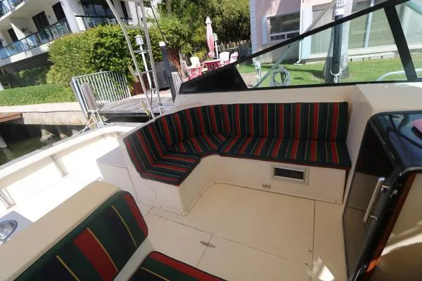 Slide: The Image of Interior of 1991 Atlantic 38 Super Sport boat with striped seating. - 12