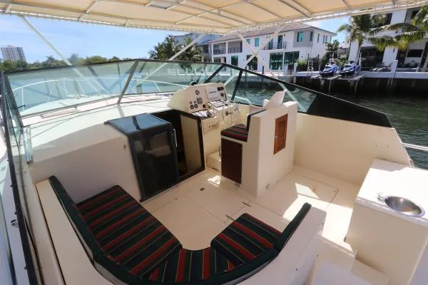 Slide: The Image of 1991 Atlantic 38 Super Sport yacht cockpit with striped seating and control panel. - 13