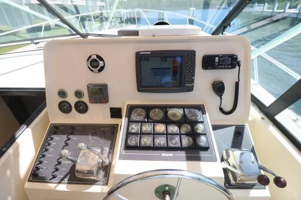 Slide: The Image of 1991 Atlantic 38 Super Sport boat dashboard with navigation instruments and controls. - 14