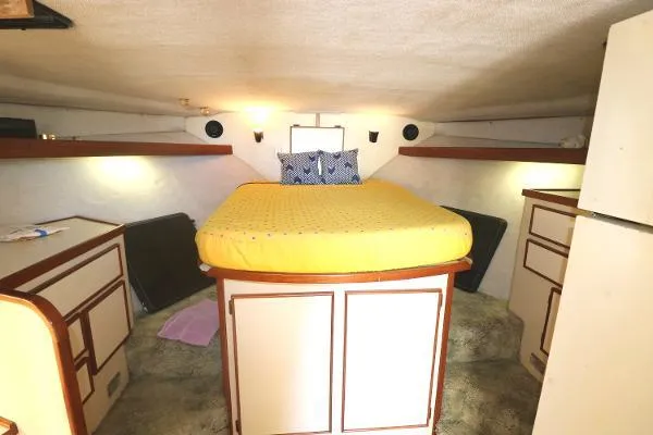 Slide: The Image of Cozy cabin interior of 1991 Atlantic 38 Super Sport with yellow bedding and wooden accents. - 18