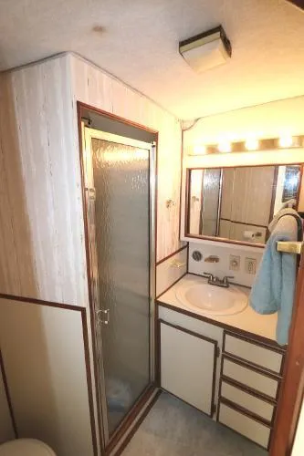 Slide: The Image of 1991 Atlantic 38 Super Sport bathroom with shower, vanity, and mirror. - 20