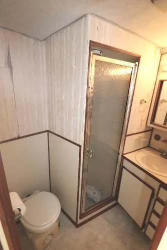 Slide: The Image of Bathroom in 1991 Atlantic 38 Super Sport boat with shower, toilet, and sink. - 21