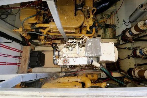 Slide: The Image of Engine room of a 1991 Atlantic 38 Super Sport boat, showcasing mechanical components. - 23