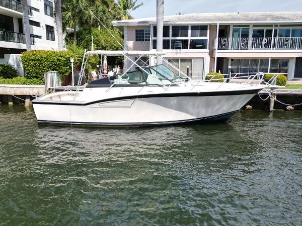Slide: The Image of 1991 Atlantic 38 Super Sport boat docked near waterfront homes. - 3