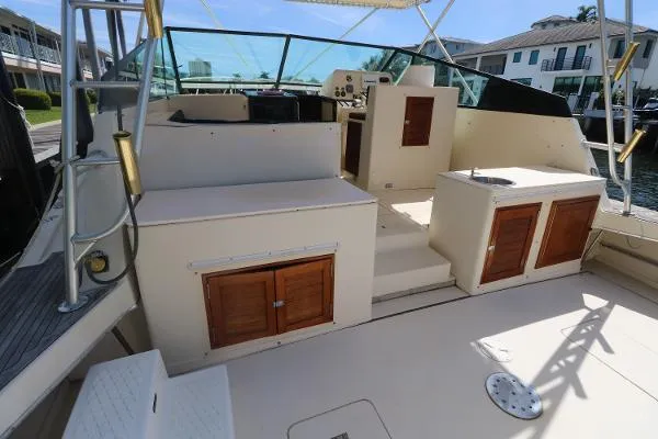 Slide: The Image of 1991 Atlantic 38 Super Sport boat interior with wooden cabinets and helm station. - 4