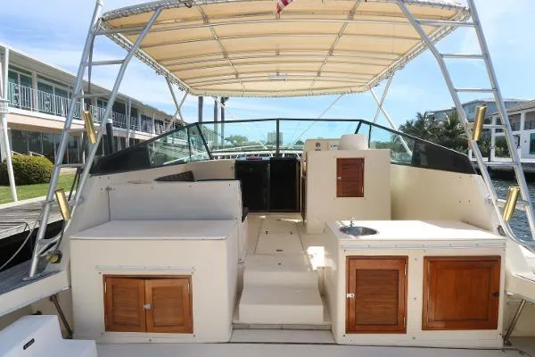 Slide: The Image of 1991 Atlantic 38 Super Sport boat interior with canopy and wooden cabinets. - 5