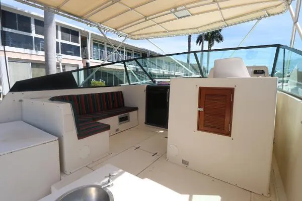 Slide: The Image of 1991 Atlantic 38 Super Sport boat interior with seating and canopy. - 9
