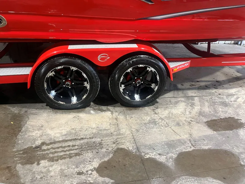 Slide: The Image of Red 2022 Crownline 240 SS LPX boat trailer with black alloy wheels. - 14