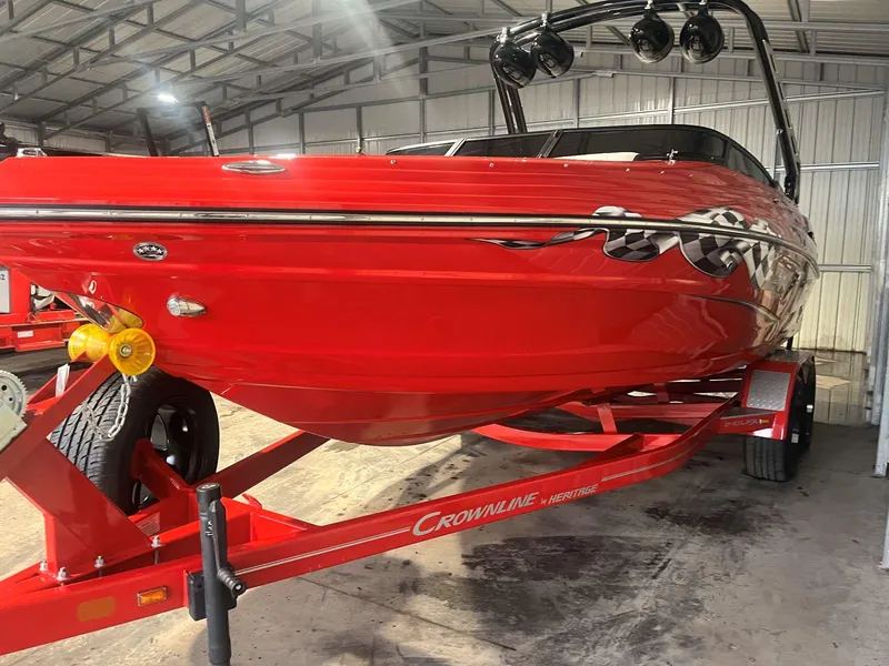 Slide: The Image of 2022 Crownline 240 SS LPX boat in vibrant red on trailer, stored indoors. - 3