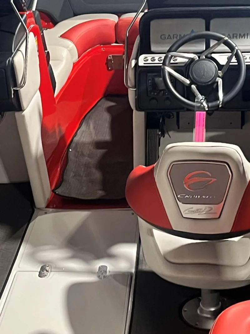 Slide: The Image of 2022 Crownline 240 SS LPX boat interior with red and white seating and steering wheel. - 7