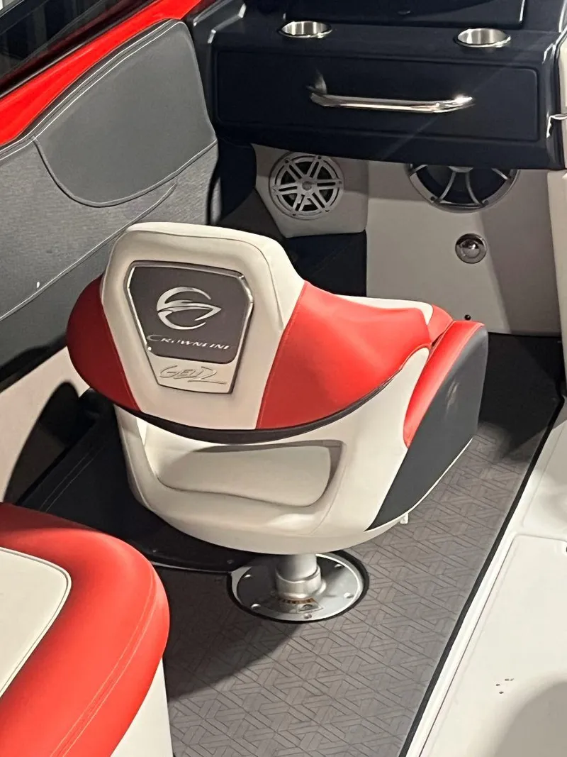 Slide: The Image of 2022 Crownline 240 SS LPX boat interior with red and white seating and modern dashboard. - 8