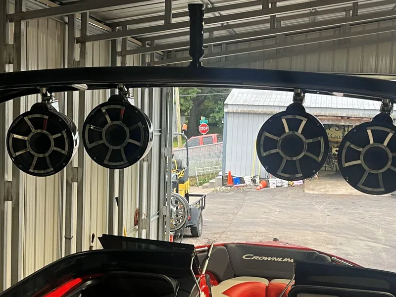 Slide: The Image of Crownline 240 SS LPX boat with mounted speakers in a garage, 2022 model. - 9