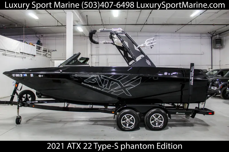 Slide: The Image of 2021 ATX 22 Type-S Phantom Edition boat in showroom, side view, on trailer. - 0