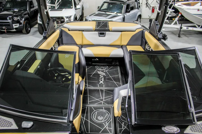 Slide: The Image of 2021 ATX Surf Boats 22 Type-S interior with tan and black seating, open windshield. - 18
