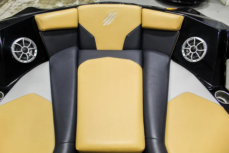 Slide: The Image of 2021 ATX Surf Boats 22 Type-S interior with tan and black seating, featuring built-in speakers. - 21
