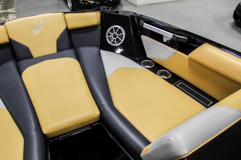 Slide: The Image of 2021 ATX Surf Boats 22 Type-S interior with tan and black seating, speaker, and cup holders. - 22