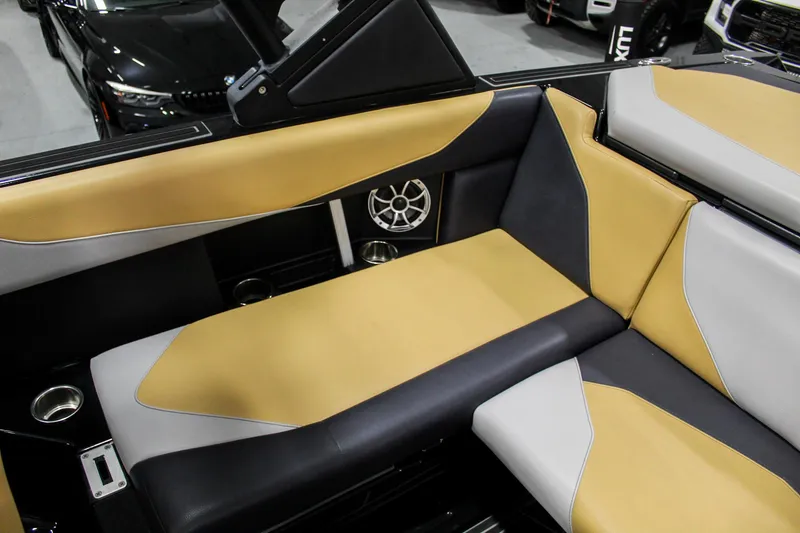 Slide: The Image of 2021 ATX Surf Boats 22 Type-S interior with tan and gray seating, featuring built-in speakers. - 28