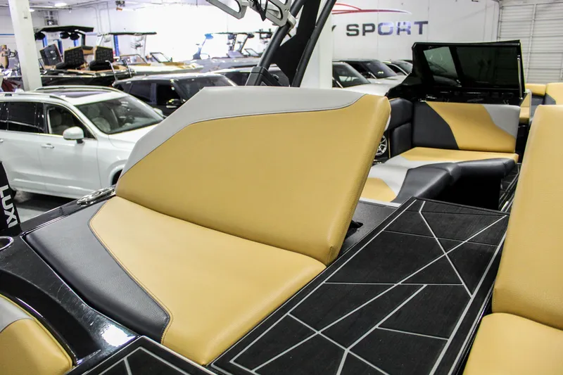 Slide: The Image of 2021 ATX Surf Boats 22 Type-S interior with tan and black seating in showroom. - 31