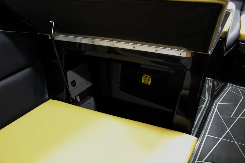 Slide: The Image of 2021 ATX Surf Boats 22 Type-S interior storage compartment with yellow and black seating. - 35