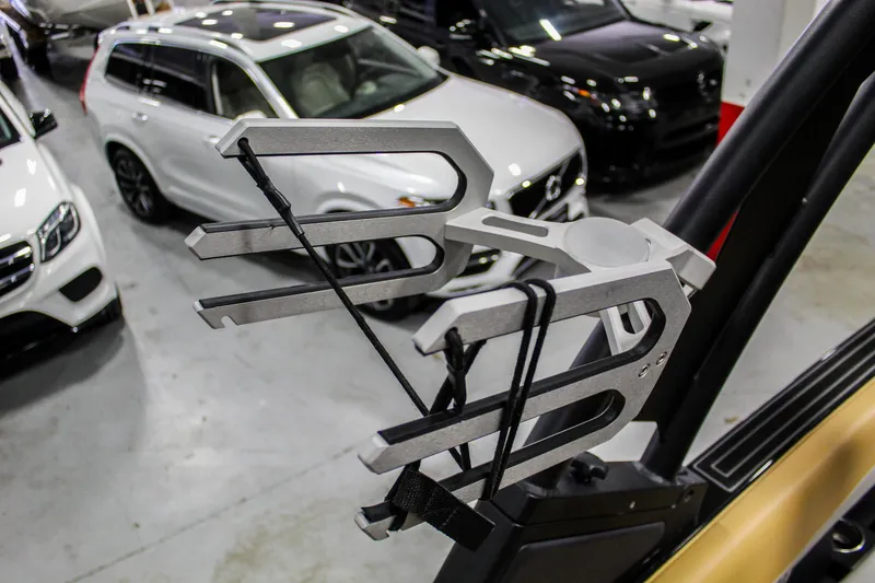 Slide: The Image of Wakeboard rack on 2021 ATX Surf Boats 22 Type-S, with cars in the background. - 38