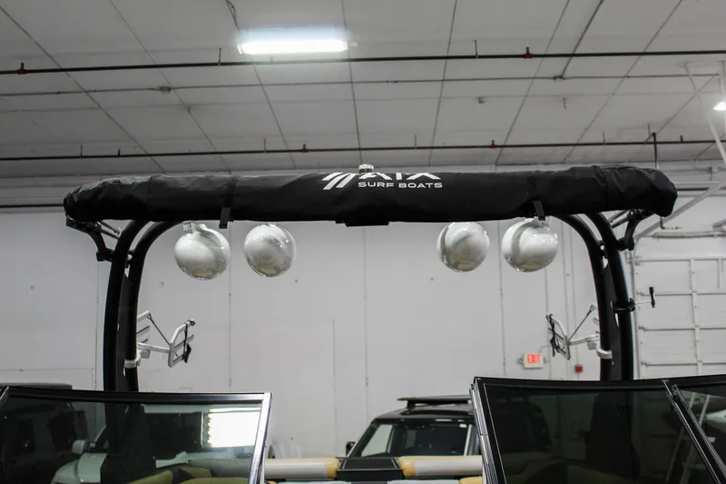 Slide: The Image of 2021 ATX Surf Boats 22 Type-S with wakeboard tower in a garage setting. - 48