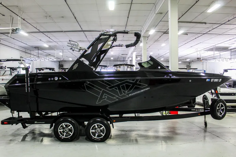 Slide: The Image of 2021 ATX Surf Boats 22 Type-S, black, in a showroom on a trailer. - 7
