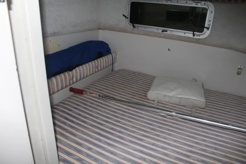 Slide: The Image of Interior cabin of 1992 Stamas 288 Liberty boat with striped bedding and window. - 18