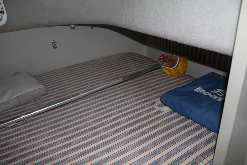 Slide: The Image of Interior cabin of 1992 Stamas 288 Liberty boat with striped bedding and cleaning brush. - 19