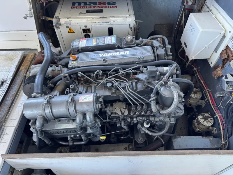 Slide: The Image of 1978 Bertram 31 Sportfisher Yanmar engine in boat compartment, showcasing detailed mechanical components. - 11