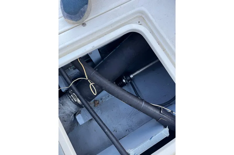 Slide: The Image of Engine compartment of 1978 Bertram 31 Sportfisher Yanmars, showing hoses and fittings. - 19