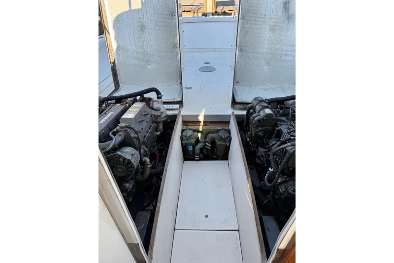 Slide: The Image of 1978 Bertram 31 Sportfisher Yanmars engine compartment with dual engines visible. - 20
