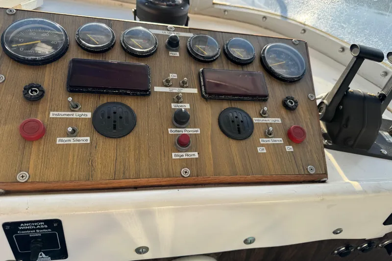 Slide: The Image of Control panel of a 1978 Bertram 31 Sportfisher Yanmars boat with gauges and switches. - 22
