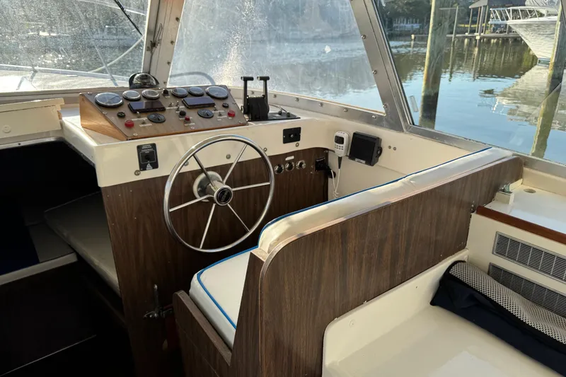 Slide: The Image of 1978 Bertram 31 Sportfisher Yanmars helm with classic wooden dashboard and steering wheel. - 24