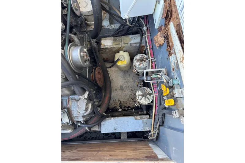 Slide: The Image of Engine compartment of a 1978 Bertram 31 Sportfisher Yanmars, showing mechanical components and wiring. - 27