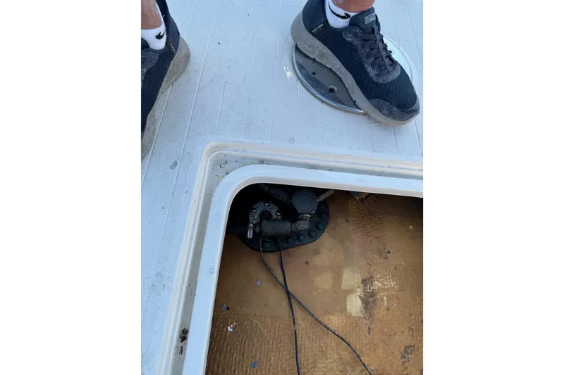 Slide: The Image of 1978 Bertram 31 Sportfisher Yanmars deck inspection with open hatch and visible wiring. - 30