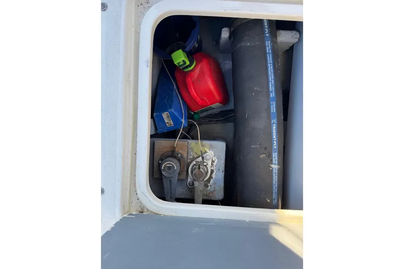 Slide: The Image of 1978 Bertram 31 Sportfisher Yanmars engine compartment with fuel container and mechanical components. - 31
