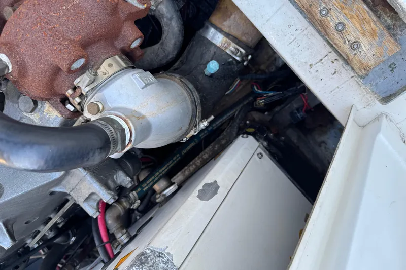 Slide: The Image of Engine compartment of a 1978 Bertram 31 Sportfisher Yanmars, showing hoses and components. - 34