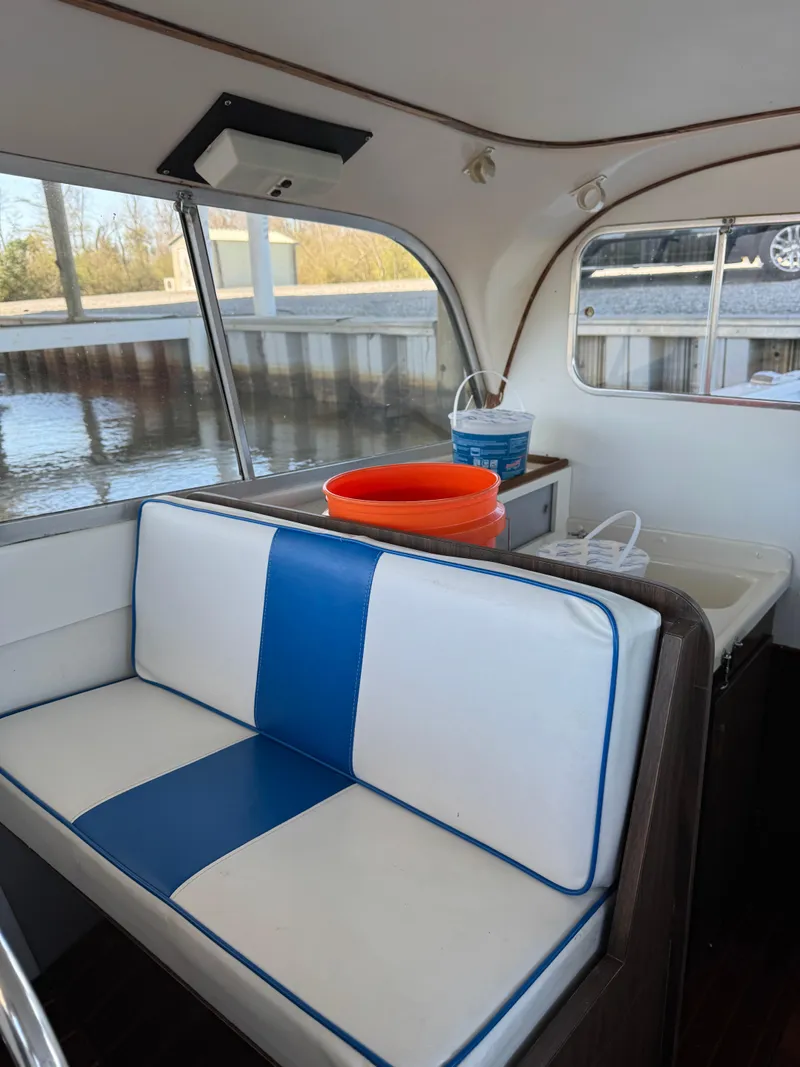 Slide: The Image of 1978 Bertram 31 Sportfisher Yanmars interior with blue and white seating, dockside view. - 5