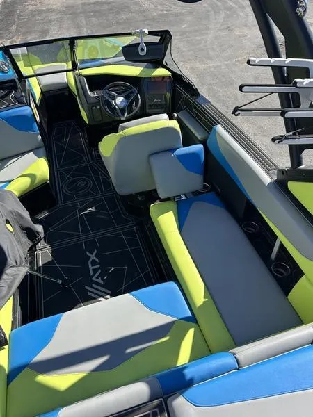 Slide: The Image of 2022 ATX Surf Boats 22 Type-S interior with vibrant blue and green seating. - 3