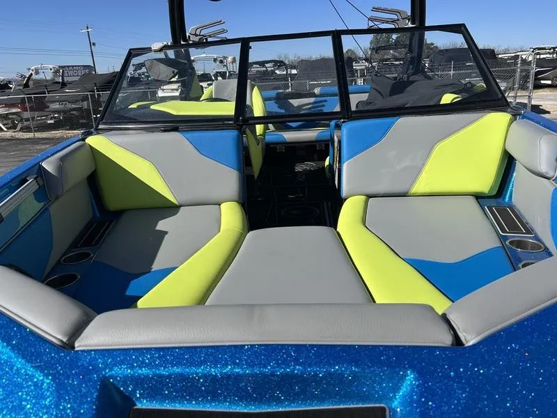 Slide: The Image of 2022 ATX Surf Boats 22 Type-S interior with vibrant blue, gray, and lime green seating. - 4