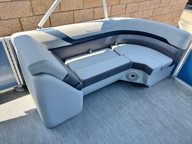 Slide: The Image of 2023 Bennington SX 21 pontoon boat seating with gray upholstery and integrated speaker. - 10