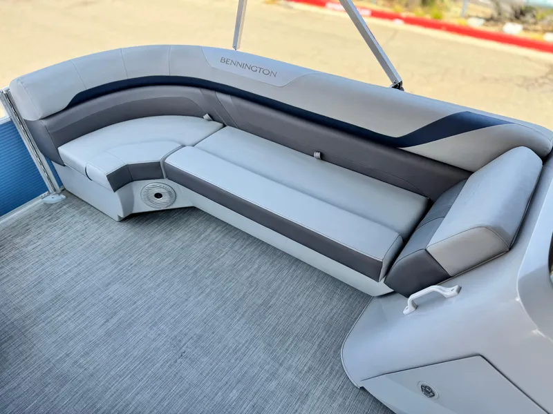 Slide: The Image of 2023 Bennington SX 21 boat interior with gray seating and speaker. - 11