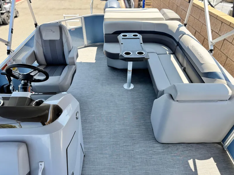 Slide: The Image of 2023 Bennington SX 21 pontoon boat interior with gray seating and steering console. - 13